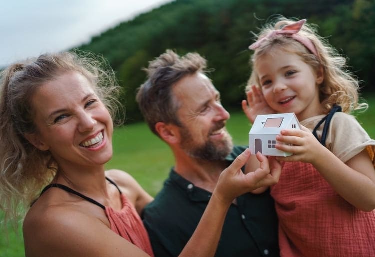 Family of three smiling, knowing what questions to ask home warranty companies.