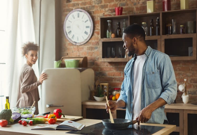 Couple cooking together in the kitchen.