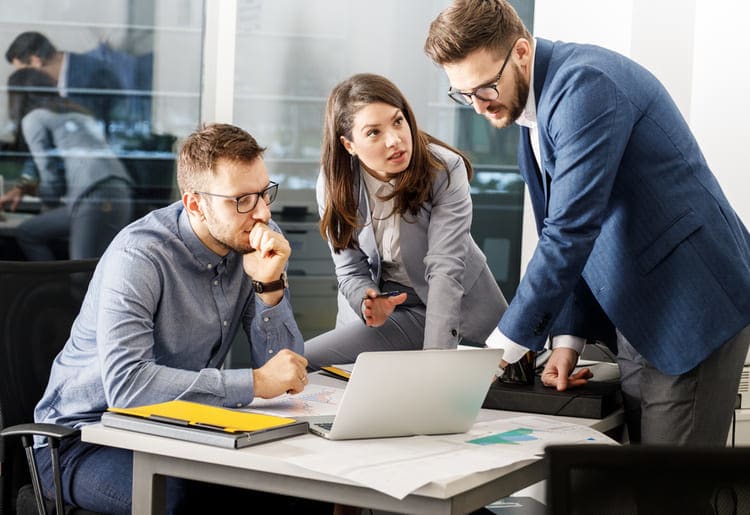 Group of colleagues performing a detailed background check of a potential candidate in an office.