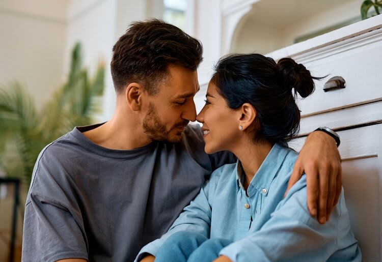 Man and women lovingly touching faces.