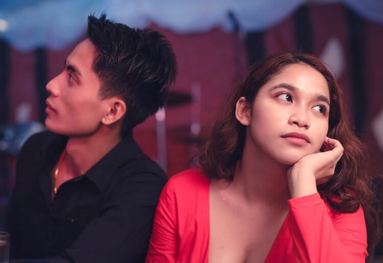 Unhappy couple looking away from each other.