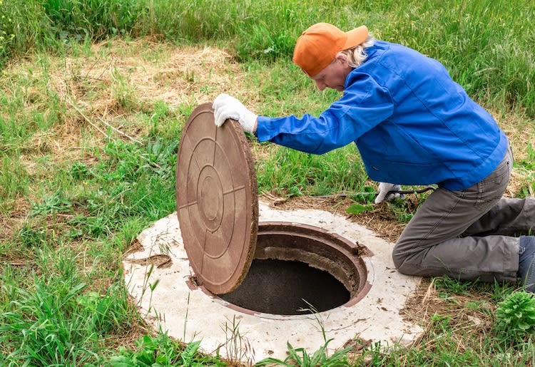 A man checks his septic tank.