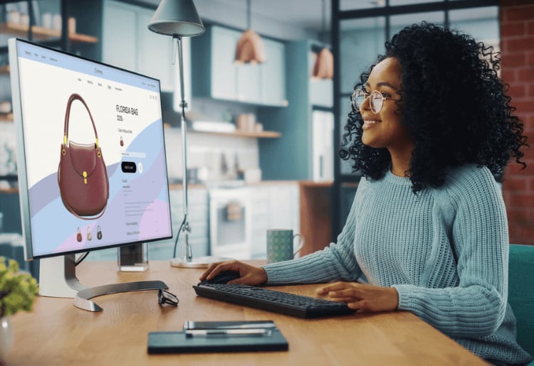 a woman sitting at a desk in front of a computer